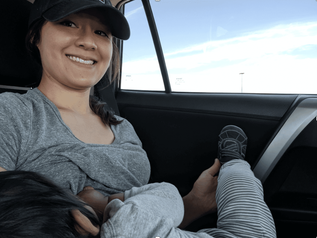 Toddler breastfeeding in car