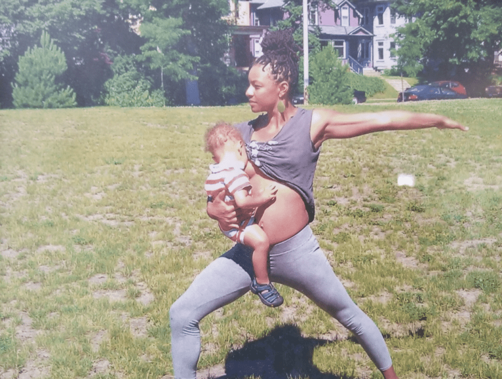 Child breastfeeding while mom is doing yoga