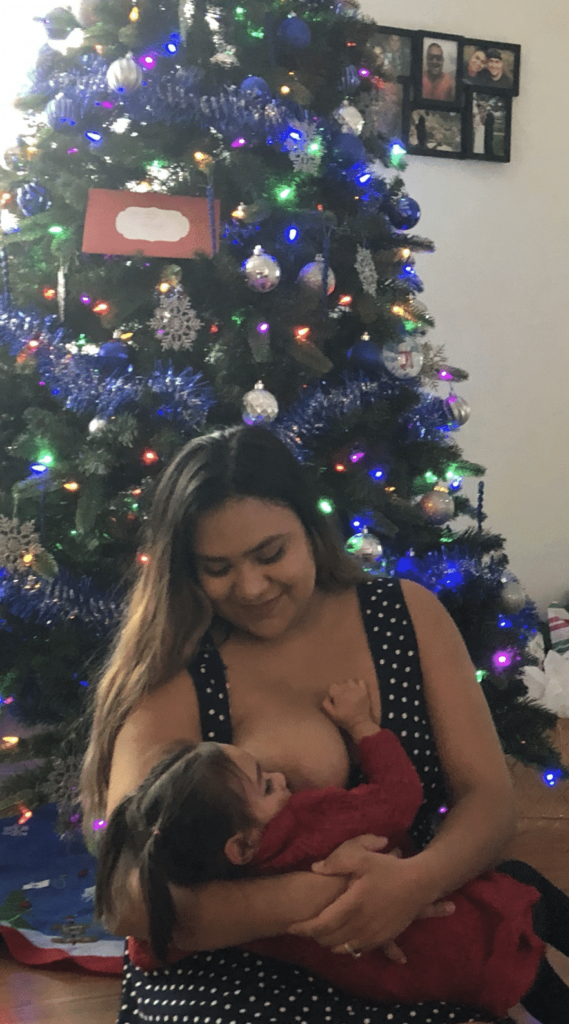 Breastfeeding in front of a Christmas tree