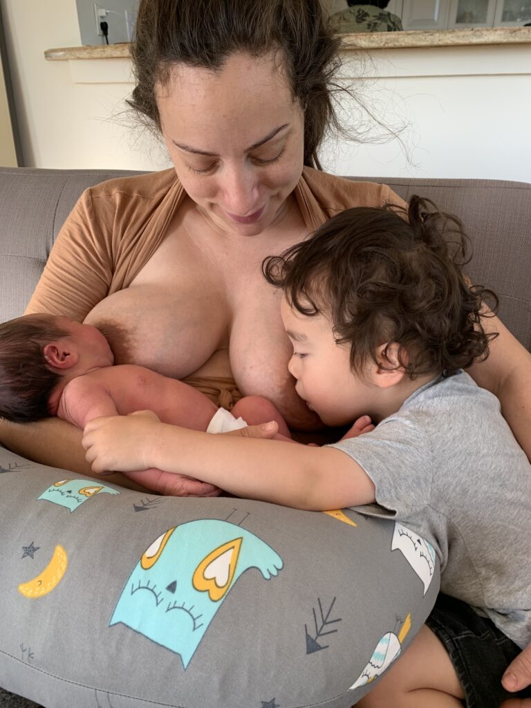 Tandem nursing newborn and three year old